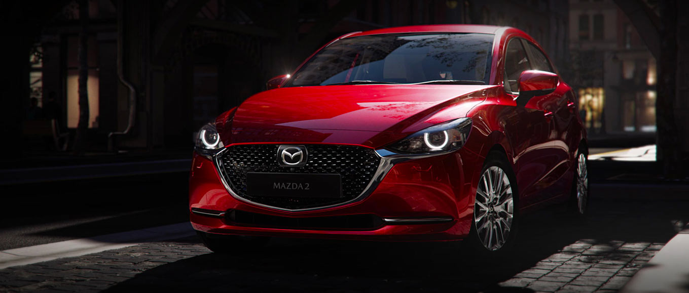 Mazda 2 sedán 2023 en México diseño exterior color rojo, frente con faros LED y luces diurnas