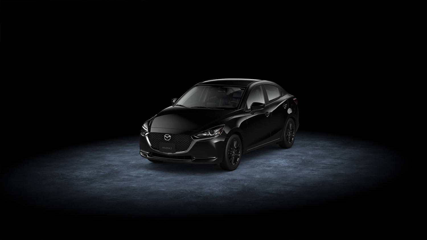 Mazda 2 sedán 2023 Carbon Edition MHEV en México diseño exterior rines en color negro, frente y lateral izquierdo