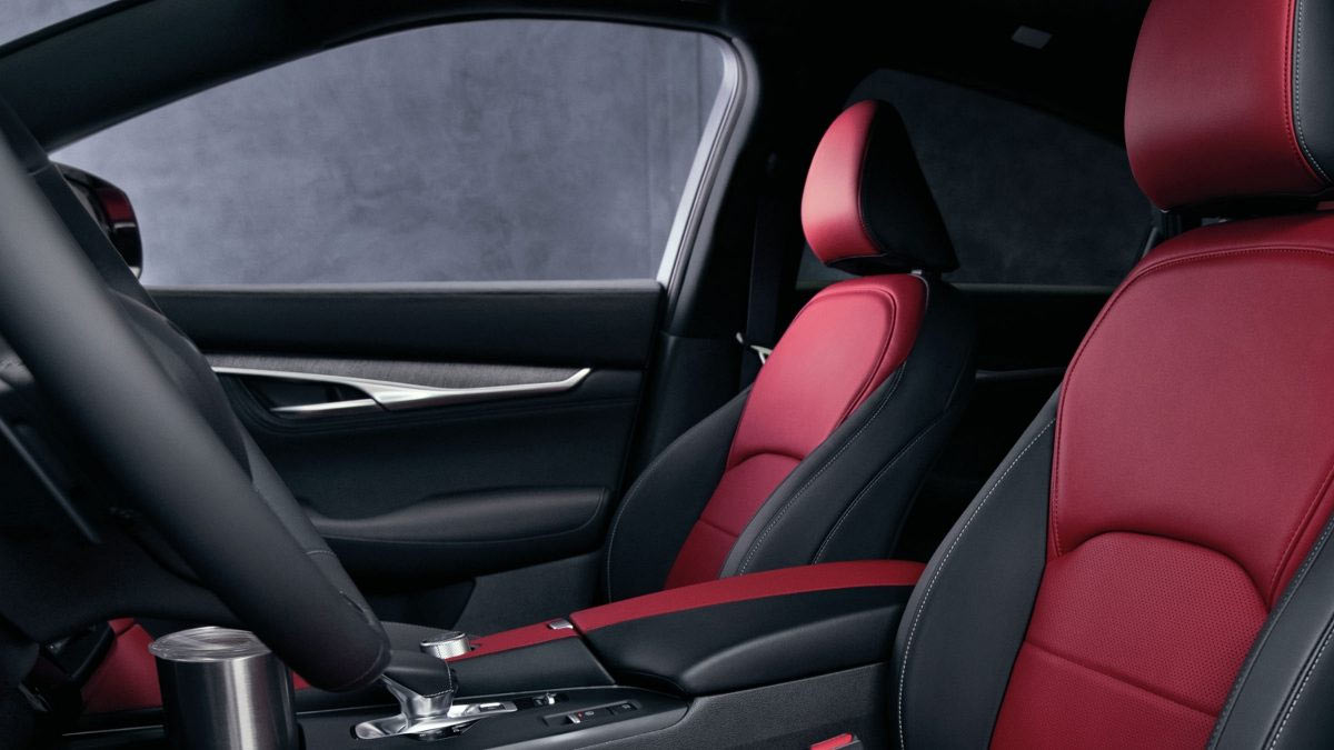 Nuevo Infiniti QX55 2023 en México, color rojo diseño interior amplio con asientos en piel bicolor y consola central con controles