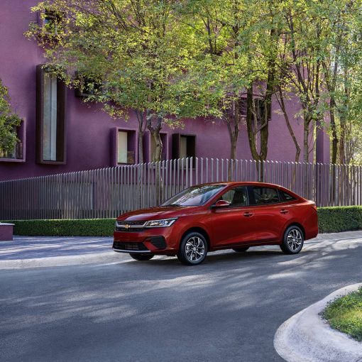 Chevrolet Aveo sedán 2024 en México color rojo en calle parte frontal y lateral