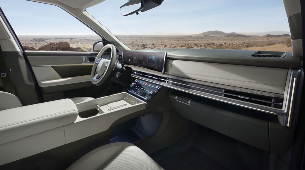 Hyundai Santa Fe 2024 diseño interior moderno con amplios espacios - Asientos, volante, pantallas y consola centrar con espacios para diversos objetos